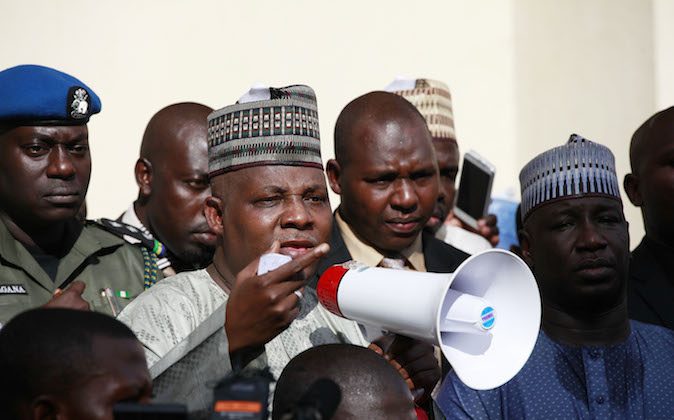 Borno state governor, Kashim Shettima, centre, addresses demonstrators who were calling on the government to rescue the kidnapped schoolgirls of the Chibok secondary school, in Abuja, Nigeria, Tuesday, May 13, 2014. A Nigerian government official said "all options are open" in efforts to rescue almost 300 abducted schoolgirls from their captors as US reconnaissance aircraft started flying over this West African country in a search effort.  Boko Haram, the militant group that kidnapped the girls last month from a school in Borno state, had released a video yesterday purporting to show some of the girls. A civic leader said representatives of the missing girls' families were set to view the video as a group later today to see if some of the girls can be identified. (AP Photo / Sunday Alamba)