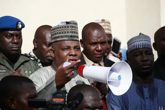 Borno state governor, Kashim Shettima, centre, addresses demonstrators who were calling on the government to rescue the kidnapped schoolgirls of the Chibok secondary school, in Abuja, Nigeria, Tuesday, May 13, 2014. A Nigerian government official said "all options are open" in efforts to rescue almost 300 abducted schoolgirls from their captors as US reconnaissance aircraft started flying over this West African country in a search effort.  Boko Haram, the militant group that kidnapped the girls last month from a school in Borno state, had released a video yesterday purporting to show some of the girls. A civic leader said representatives of the missing girls' families were set to view the video as a group later today to see if some of the girls can be identified. (AP Photo / Sunday Alamba)