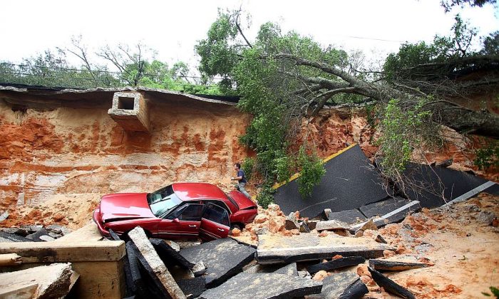 The damage on Scenic Highway after part of the highway collapsed following heavy rains and flash flooding in Pensacola, Fla., on April 30, 2014. (Marianna Massey/Getty Images)