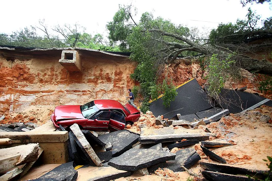 The damage on Scenic Highway after part of the highway collapsed following heavy rains and flash flooding in Pensacola, Fla., on April 30, 2014. (Marianna Massey/Getty Images)