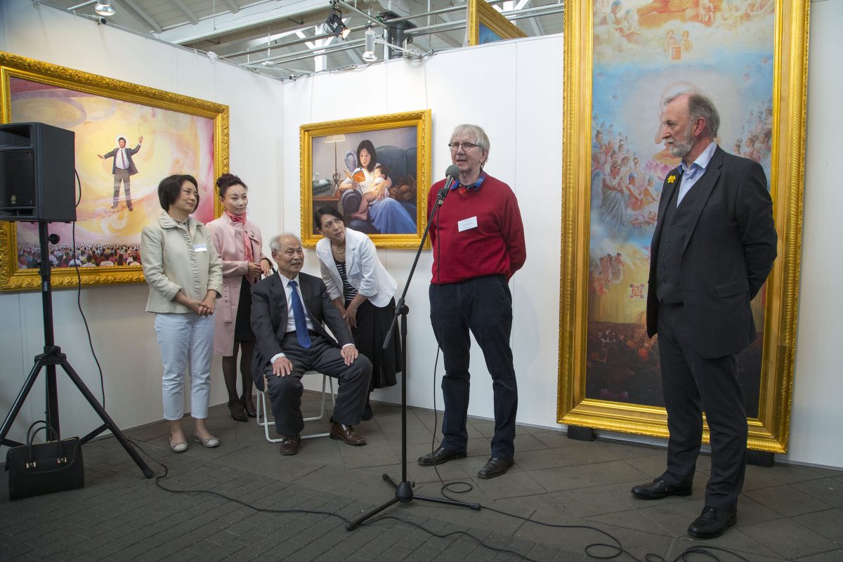 Amy Lee, painter (far left), Professor Kunlun Zhang, sculptor, painter, and founder of The Art of Zhen Shan Ren International Exhibition (seated), Boi Wynsch, organiser of Art Nordic, in red jumper, speaking, and Eddie Aitkin, Director and Trustee of Zhen Shan Ren Arts (UK) standing, right. (Simon Gross/Epoch Times)