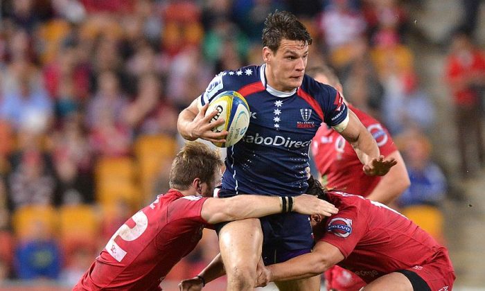 Running to victory ... Rebels centre Mitch Inman takes on the Reds during their Round 14 Super Rugby match on May 17, 2014. (Bradley Kanaris/Getty Images)