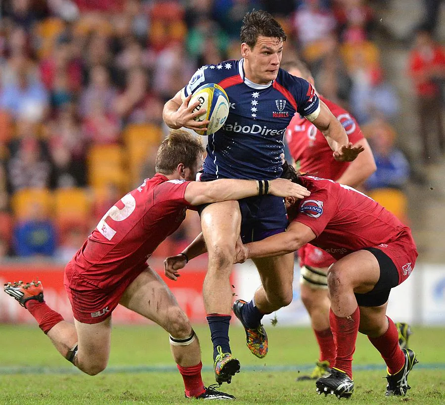Running to victory ... Rebels centre Mitch Inman takes on the Reds during their Round 14 Super Rugby match on May 17, 2014. (Bradley Kanaris/Getty Images)