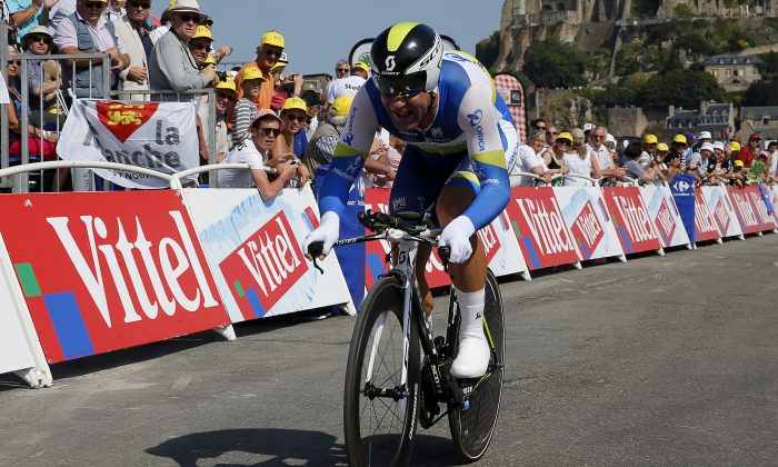Canada's Svein Tuft smiles as he is about to cross the finish line in Stage 11 of the 2013 Tour de France, July 10, 2013. On May 9, 2014, he finished first in Stage One of the Giro d'Italia. (Pascal Guyot/AFP/Getty Images)