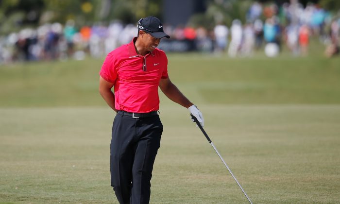 Tiger Woods grimages after playing a bunker shot on the fifth hole during the final round of the World Golf Championships-Cadillac Championship at Trump National Doral on March 9, 2014 in Doral, Florida. (Chris Trotman/Getty Images)