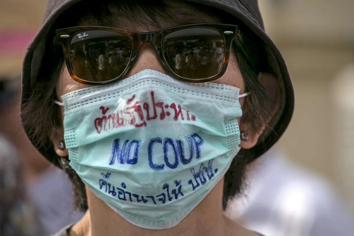 A Thai protester wears a face mask against the military coup during anti-coup protests in Bangkok, Thailand, on May 28, 2014. (Paula Bronstein/Getty Images)
