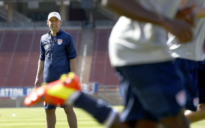 U.S. men's soccer coach Jurgen Klinsmann watches players warm up during a training session Wednesday, May 14, 2014, in Stanford, Calif. The team began a two-week training camp leading up to a May 27 exhibition with Azerbaijan at San Francisco's Candlestick Park. (AP Photo/Tony Avelar)