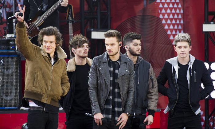FILE - This Nov. 26, 2013 file photo shows One Direction members, from left, Harry Styles, Louis Tomlinson, Liam Payne, Zayn Malik and Niall Horan on ABC's "Good Morning America"in New York. A representative for One Direction says the band’s lawyers are dealing with a video showing two band members smoking what the singers referred to as an “illegal substance.” British tabloid The Daily Mail posted a five-minute clip Tuesday, May 27, 2014, of Zayn Malik smoking and speaking with Louis Tomlinson, who is filming. (Photo by Charles Sykes/Invision/AP, File)