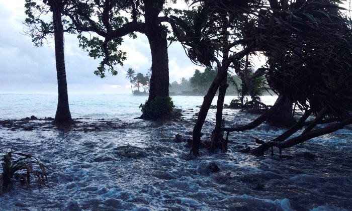 A high tide energized by storm surges washes across Ejit Island in Majuro Atoll, Marshall Islands on March 3, 2014, causing widespread flooding and damaging a number of homes. Climate change is a major concern for Pacific island states such as the Marshals, Kiribati and Tuvalu, where many atolls are barely three feet above sea level and risk being engulfed by rising waters. (Giff Johnson/AFP/Getty Images)