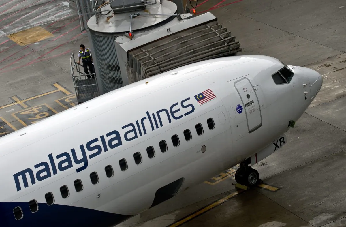 Malaysia Airlines staff board a flight prior to departure at the Kuala Lumpur International Airport in Sepang, May 14, 2014. (Manan Vatsyayana/AFP/Getty Images)