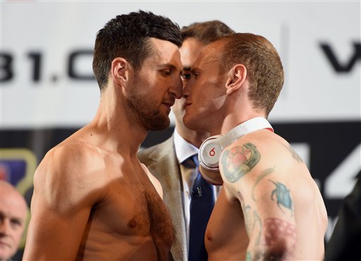 British boxers, Carl Froch, left and George Groves, go face to face, during the official weigh-in ahead of their super-middleweight world title rematch on Saturday, at Wembley Arena, in London, Friday May 30, 2014. Froch and Groves were given a taste of the atmosphere they can expect in their super-middleweight world title rematch when an estimated 7,000 raucous fans turned out just to watch their weigh-in on Friday. Both fighters made weight, with WBA and IBF champion Froch weighing 167 pounds, 9 ounces  just over a pound heavier than the challenger. (AP Photo/PA, Adam Davy) 