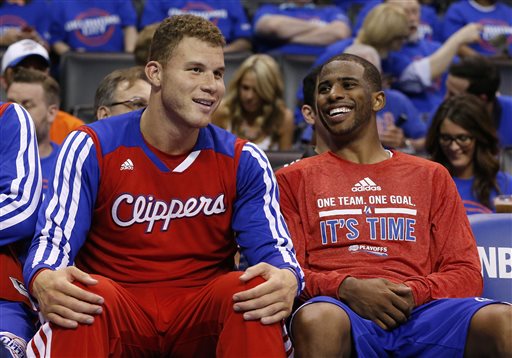 Los Angeles Clippers guard Chris Paul, right, laughs with teammate Blake Griffin, left, as they sit on the bench in the fourth quarter of Game 1 of the Western Conference semifinal NBA basketball playoff series in Oklahoma City, Monday, May 5, 2014. Los Angeles won 122-105. (AP Photo/Sue Ogrocki)