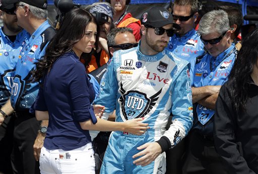 James Hinchcliffe, of Canada, watches with girlfriend Kirsten Dee as his speed is beat by Ed Carpenter to take the pole during qualifications for the Indianapolis 500 IndyCar auto race at the Indianapolis Motor Speedway in Indianapolis, Sunday, May 18, 2014. (AP Photo/Michael Conroy)