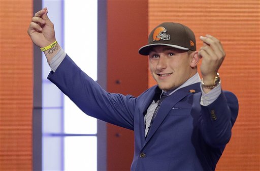 Texas A&M quarterback Johnny Manziel reacts after being selected by the Cleveland Browns as the 22nd pick in the first round of the 2014 NFL Draft, Thursday, May 8, 2014, in New York. (AP Photo/Frank Franklin II)