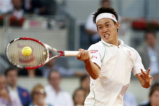 Kei Nishikori from Japan returns the ball during a Madrid Open tennis tournament match against David Ferrer from Spain in Madrid, Spain, Saturday, May 10, 2014. (AP Photo/Andres Kudacki)