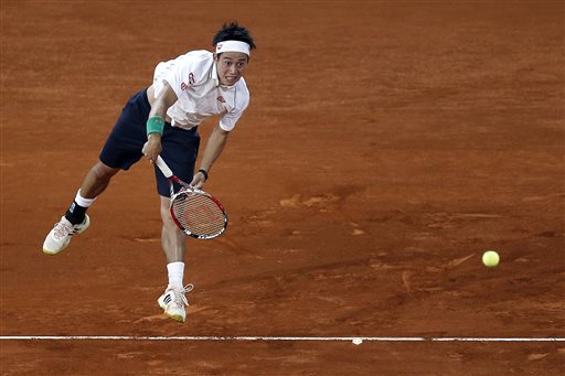 Kei Nishikori from Japan serves during a Madrid Open tennis tournament match against Feliciano Lopez from Spain in Madrid, Spain, Friday, May 9, 2014. (AP Photo/Andres Kudacki)