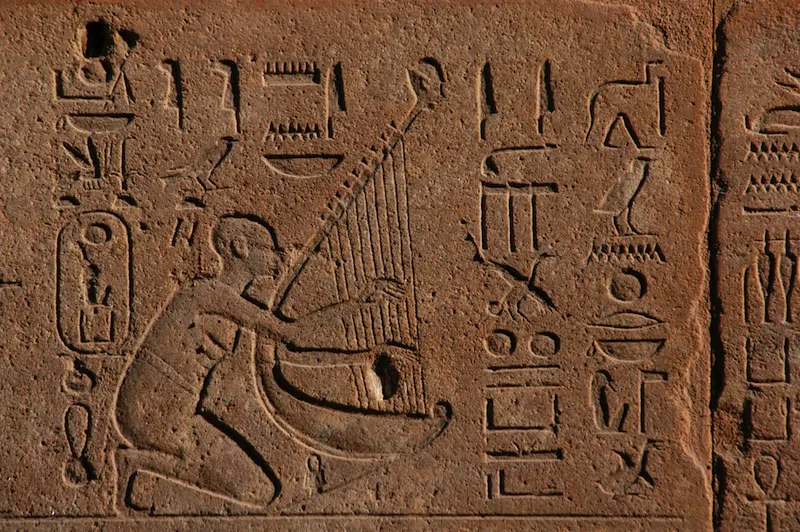 Egyptian musician playing a harp depicted in a bas-relief from Hatshepsut's Red Chapel in Karnak Temple near Luxor (Thebes), Egypt. (Shutterstock*)
