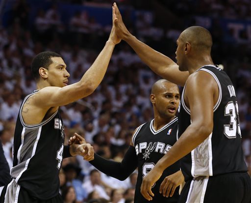 From left, San Antonio Spurs' Danny Green, Patty Mills, and Boris Diaw celebrate during the second half against the Oklahoma City Thunder in Game 6 of the Western Conference finals NBA basketball playoff series in Oklahoma City, Saturday, May 31, 2014. (AP Photo/Sue Ogrocki)