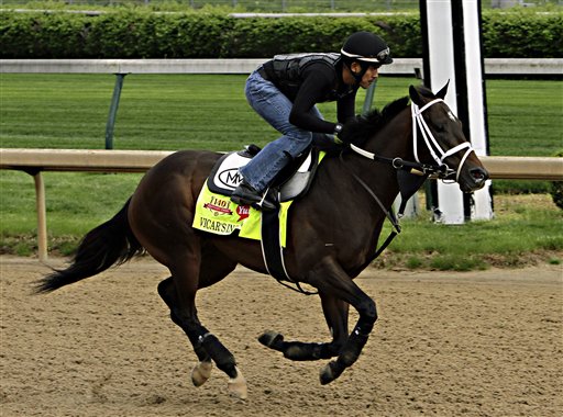 Kentucky Derby hopeful Vicar's In Trouble, ridden by exercise rider Joel Barrientos, gallops on the track at Churchill Downs in Louisville, Ky., Friday, April 25, 2014. (AP Photo/Garry Jones)