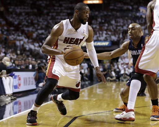 Miami Heat's Dwyane Wade, left, drives as Charlotte Bobcats' Gerald Henderson, right, defends during the first half in Game 2 of an opening-round NBA basketball playoff series, Wednesday, April 23, 2014, in Miami. (AP Photo/Lynne Sladky)