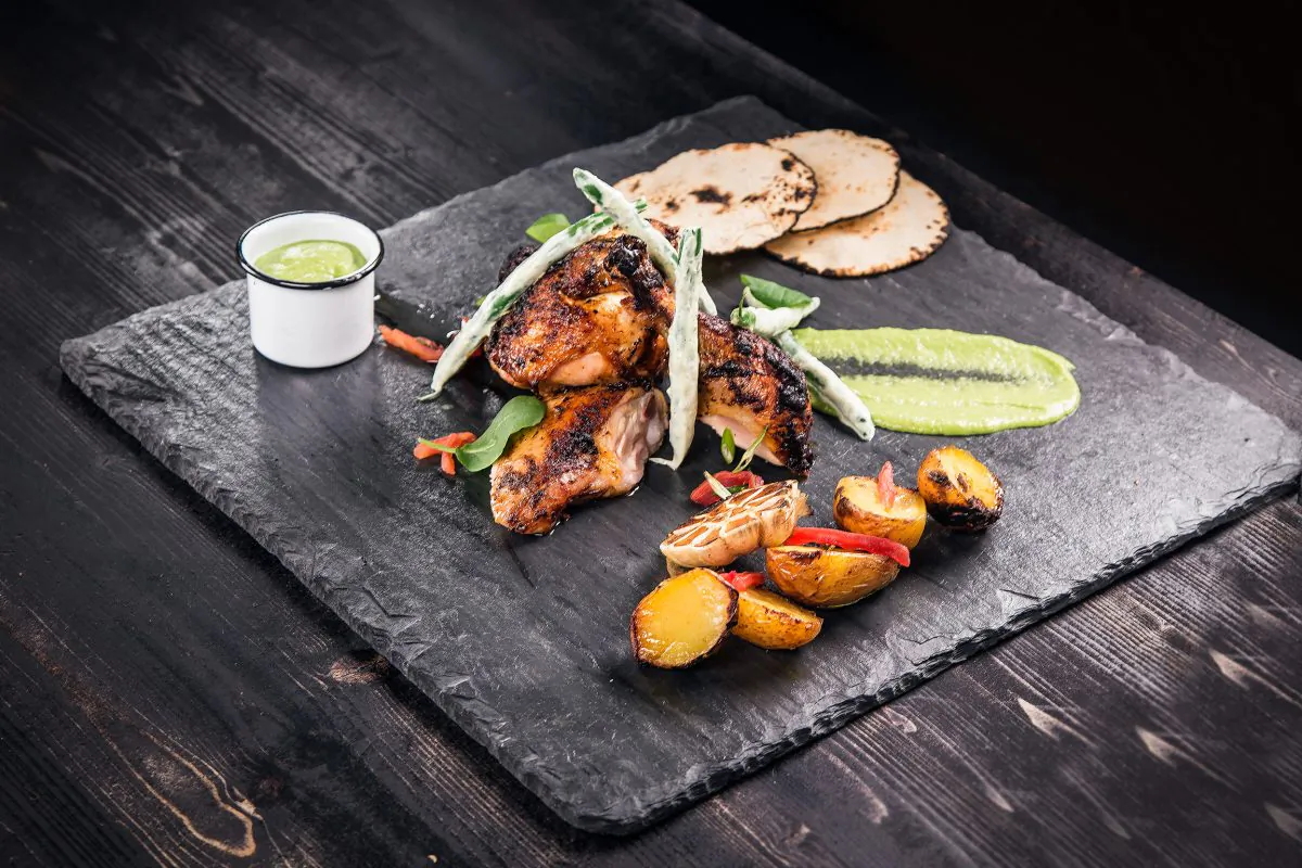 Pollo de Plaza: guajillo jerk roasted chicken, salsa cruda, creamy string beans, and tortillas. (Courtesy of Prince Rumi)
