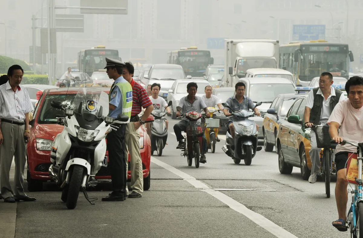 A Chinese policeman tries to resolve a traffic dispute between the driver of a luxury Porsche and another car after an accident in Beijing on Aug. 9, 2011. For the past decade China has had the highest annual number of traffic accident deaths in the world. (Mark Ralston/AFP/Getty Images) 