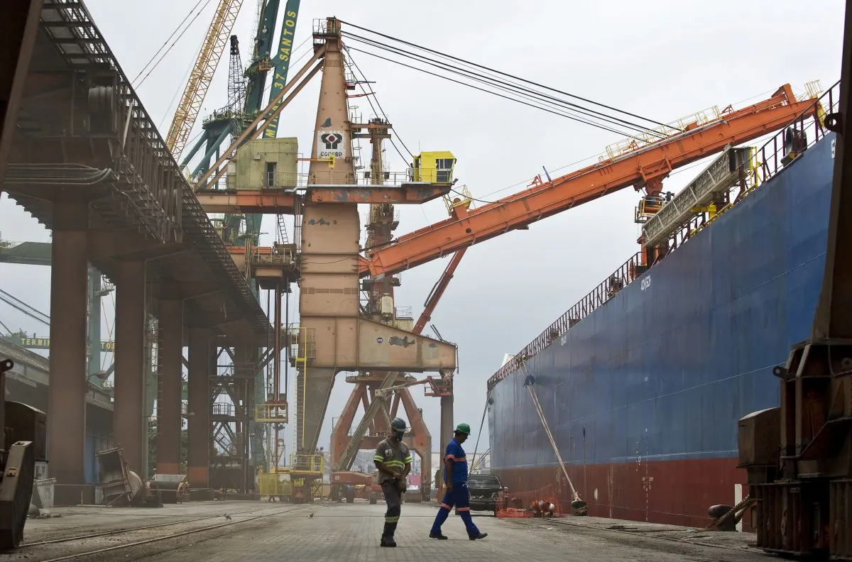 Gerardo Aziakou Dock workers walk at the port of Santos, some 60 km of Sao Paulo, Brazil, on April 1, 2013. Santos port, the biggest in Latin America, is responsible for 25 percent of Brazil's foreign trade. (Nelson Almeida/AFP/Getty Images)