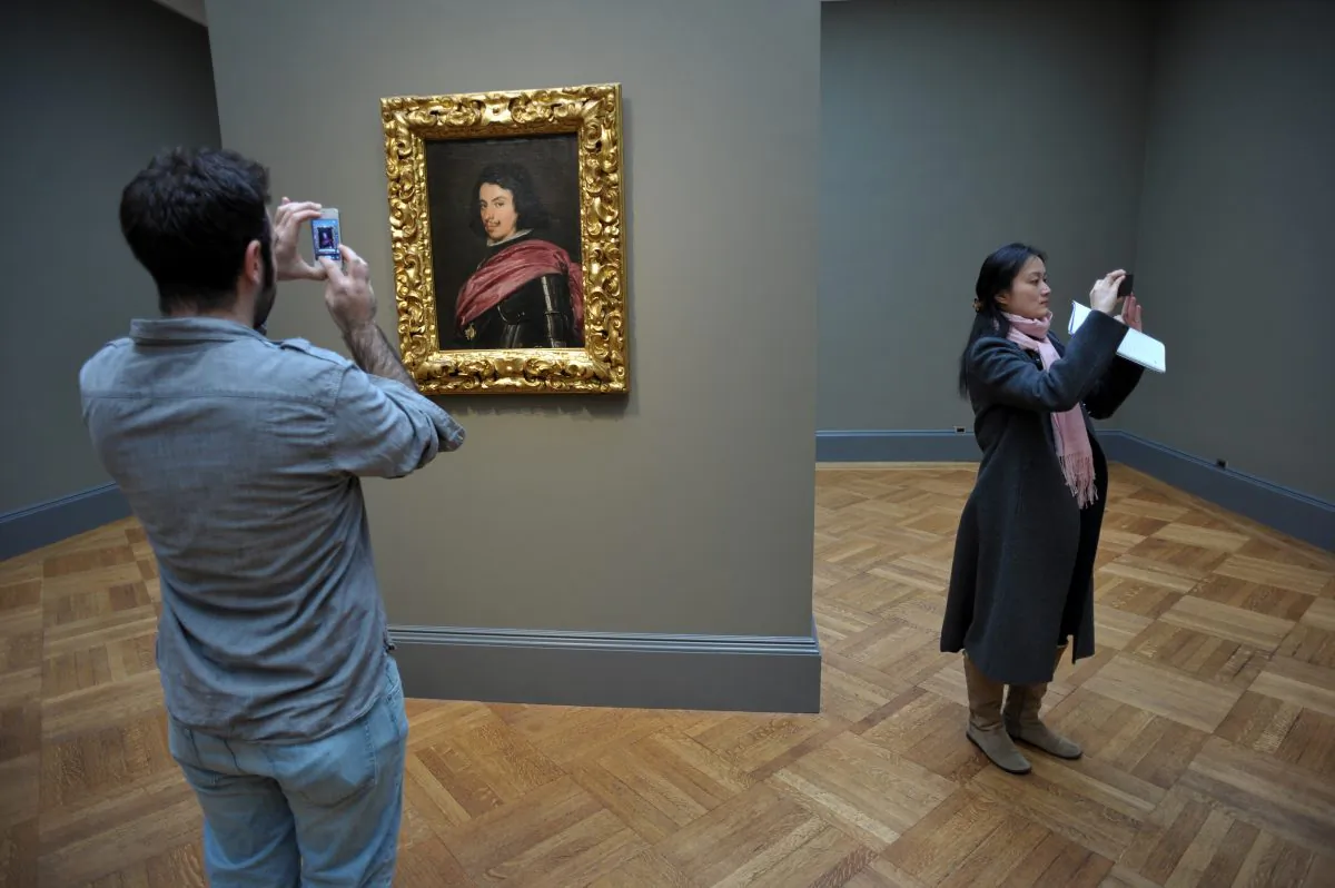 People take photographs near Spanish artist Diego Velázquez’s “Portrait of Duke Francesco I d’Este” 1638 at The Metropolitan Museum of Art, April 15, 2013, in New York. (Stan Honda/AFP/Getty Images)