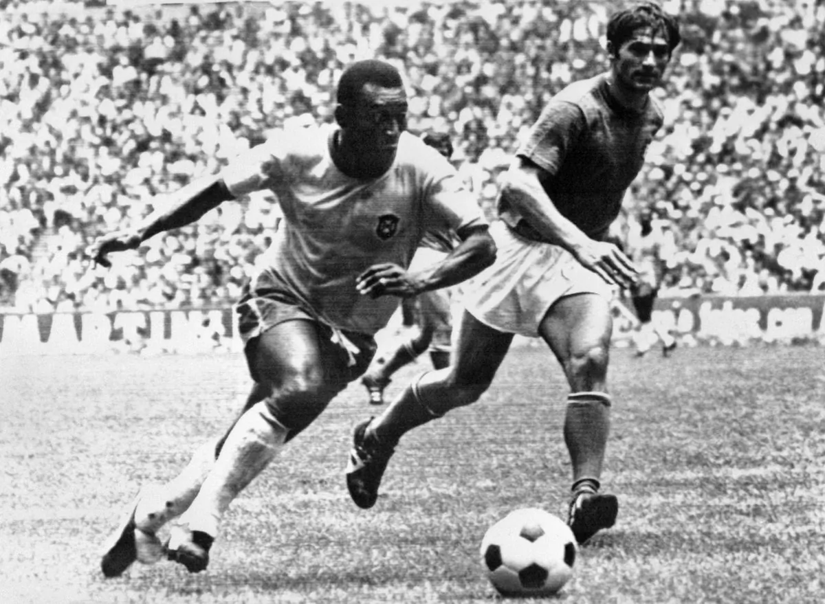 Brazilian midfielder Pelé (L) dribbles past Italian defender Tarcisio Burgnich during the World Cup final on 21 June 1970 in Mexico City. Pelé scored the opening goal for his team as Brazil went on to beat Italy 4-1 to capture its third World title after 1958 (in Sweden) and 1962 (in Chile). (AFP/Getty Images)