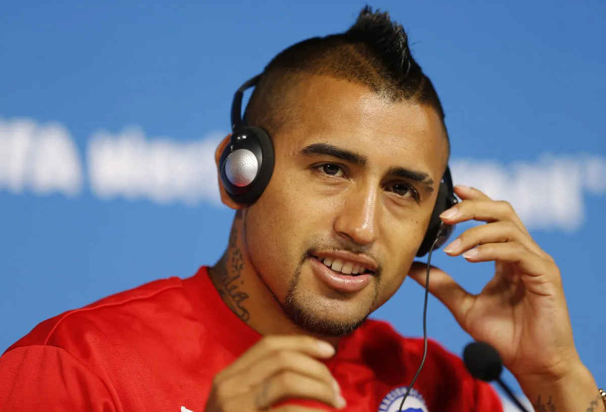 Arturo Vidal of Chile adjusts his headphones during a press conference at the Itaquerao Stadium in Sao Paulo, Brazil, Sunday, June 22, 2014. Chile will play Netherlands in a match that will decide the winner of Group B at the 2014 soccer World Cup. (AP Photo/Wong Maye-E)