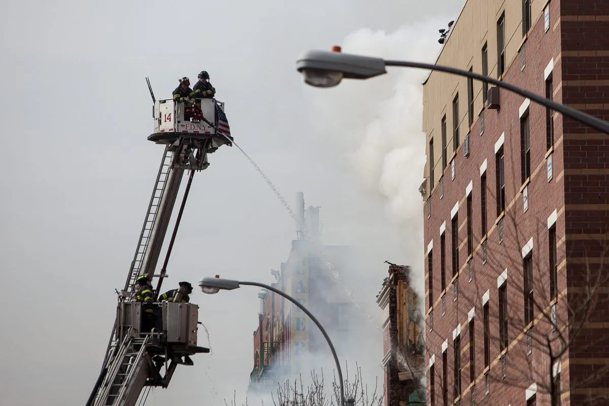 FDNY firefighters tackle the flames after a gas explosion in East Harlem on March 12. (Petr Svab/Epoch Times)