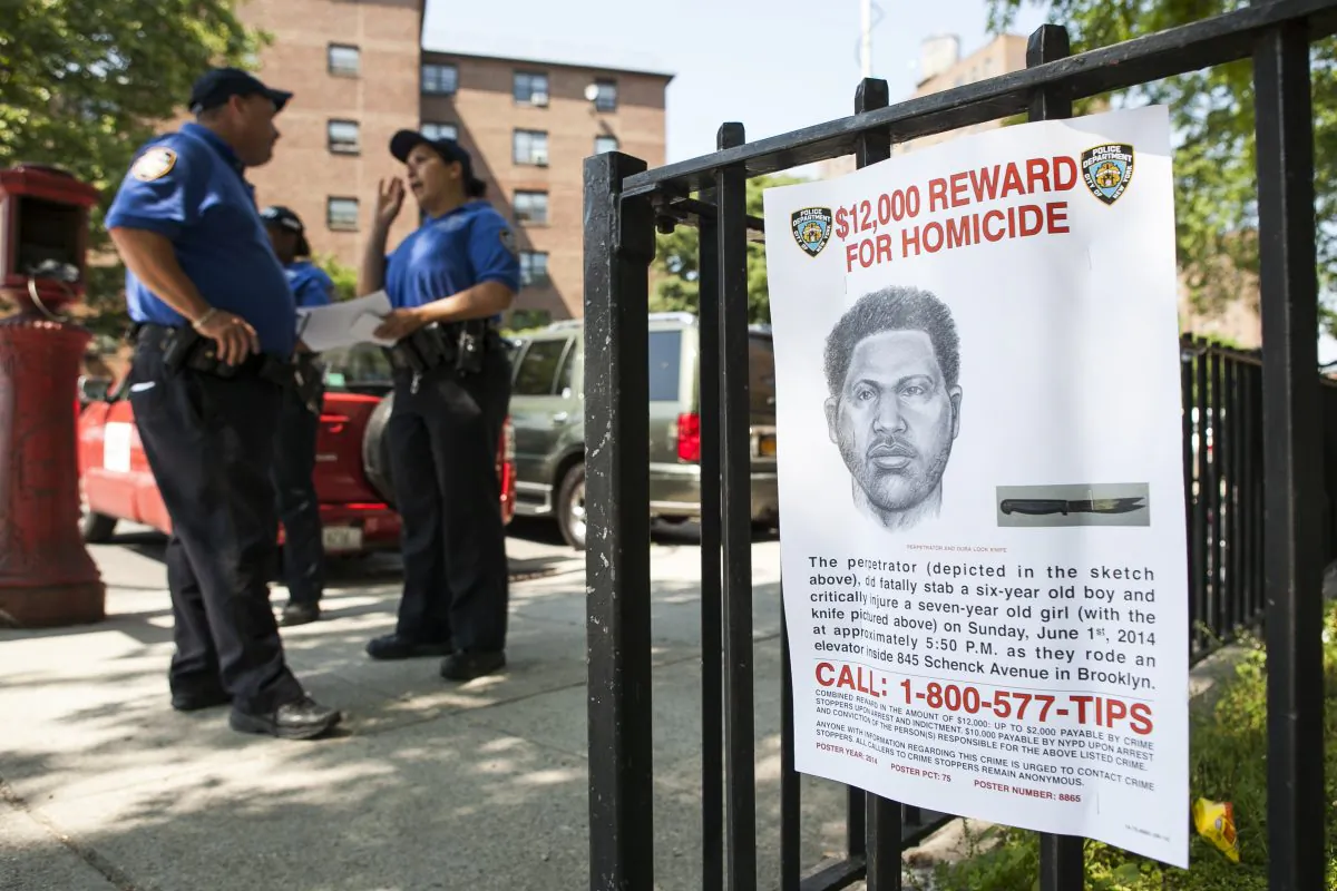 A sign depicting the perpetrator of the stabbing to death of Prince Joshua Avitto, at the Boulevard Housing project in East New York on June 3, 2014. (Samira Bouaou/Epoch Times)