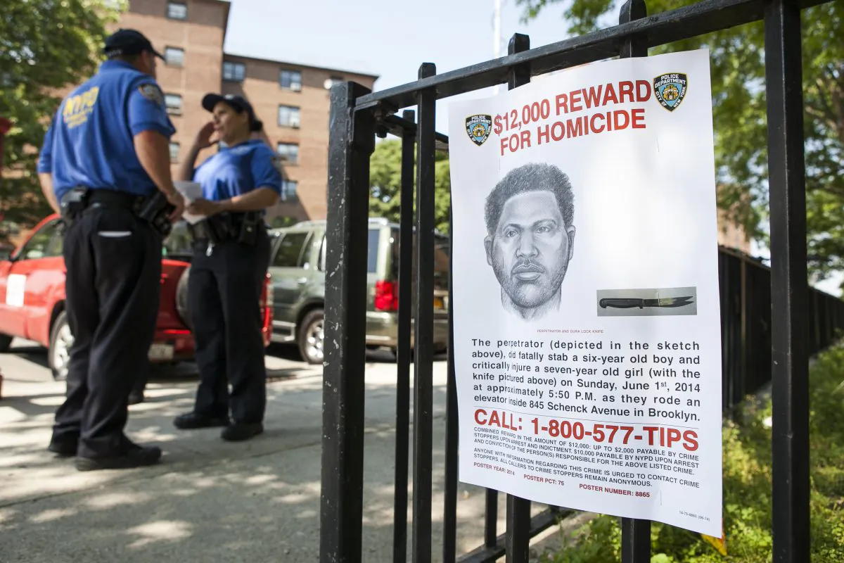 A sign depicting the perpetrator of the stabbing to death of Prince Joshua Avitto, at the Boulevard Housing project in East New York on June 3, 2014. (Samira Bouaou/Epoch Times)