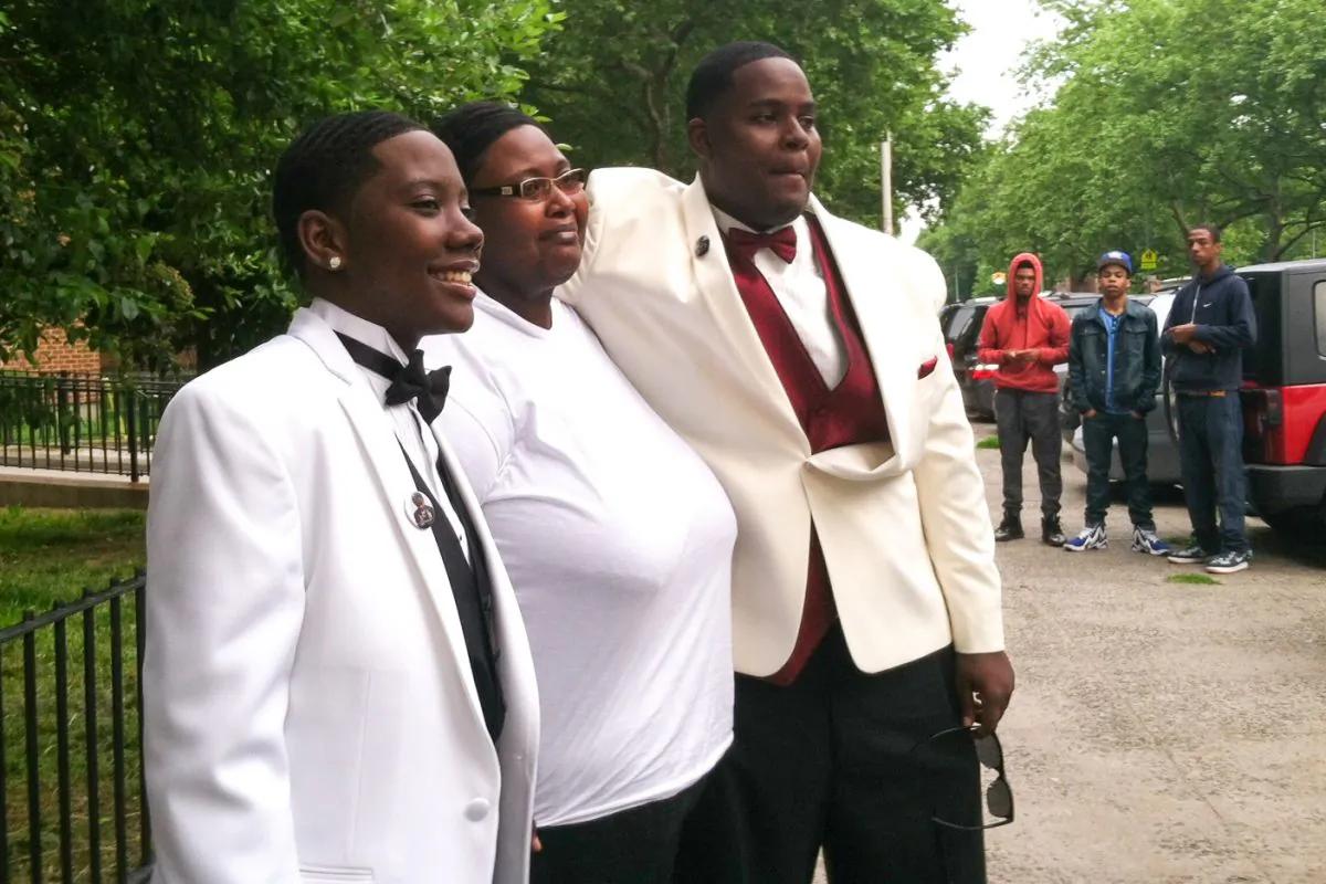 (L–R) Shakira Capers, Brigette Capers, and Christian Capers, on Wednesday, outside of the building in East New York where 7-year-old Mikayla Capers was stabbed on Sunday night. (Amelia Pang/Epoch Times)