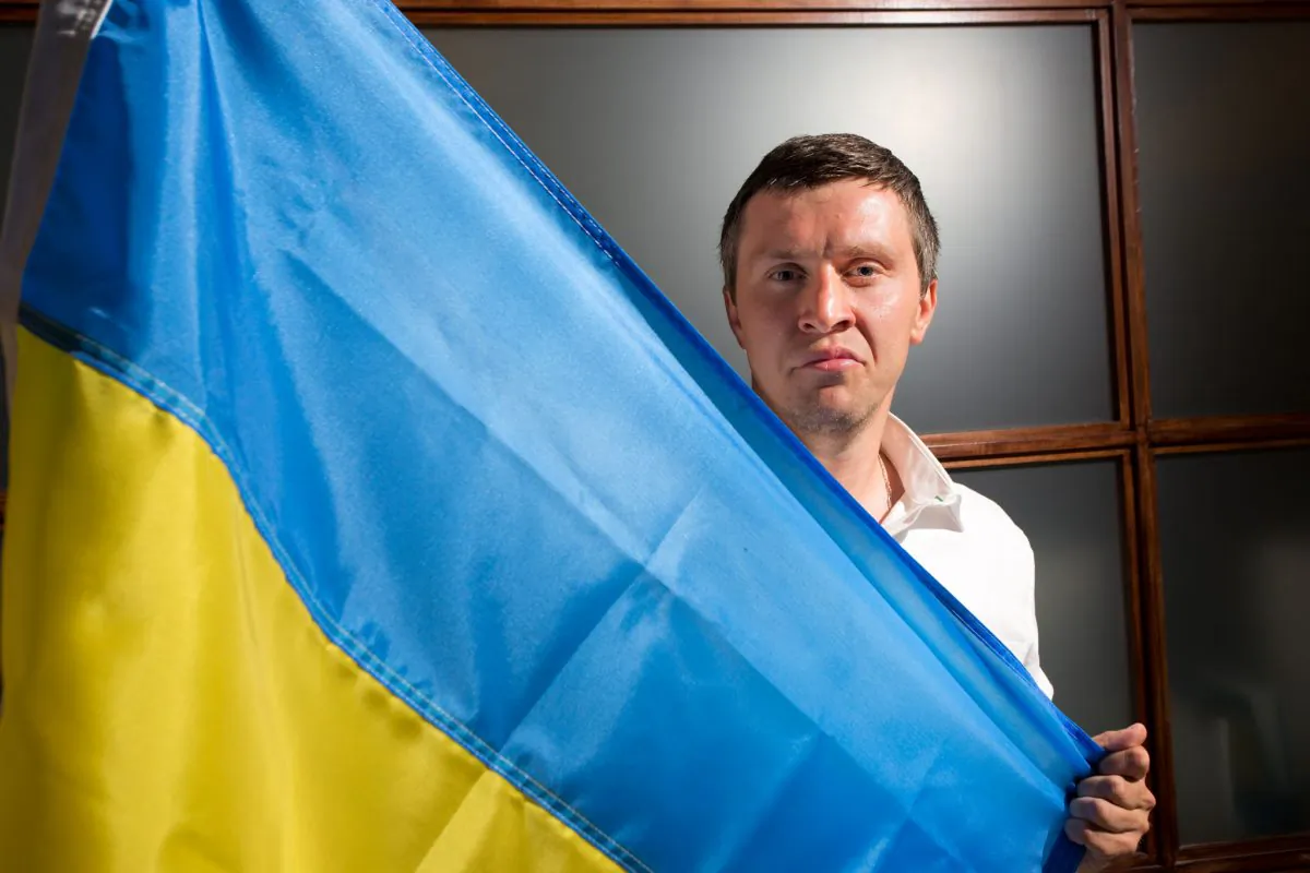 Ivan Rodichenko poses with the Ukrainian flag in Manhattan on June 11, 2014. Ivan Rodichenko fled to New York after being told he would die if he stayed in Ukraine, however, his asylum was rejected, so on June 12, he returned to Ukraine to meet his fate. (Benjamin Chasteen/Epoch Times)