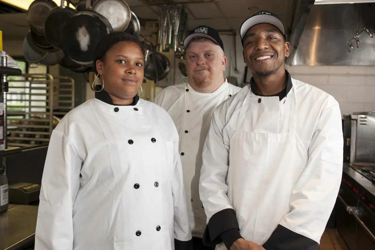 (L-R) Culinary student Katrina Green, Culinary Arts Education Director Daniel Maguire, and culinary student Evan Hill at the HELP Supportive Employment Center. (Samira Bouaou/Epoch Times)