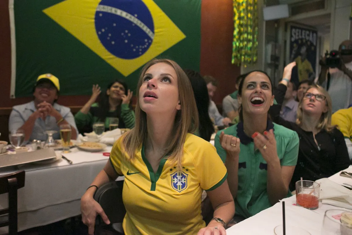 Spectators watch a Soccer World Cup game at Emporium Brasil in Manhattan's Little Brazil district, New York, June 12, 2014. (Samira Bouaou/Epoch Times)
