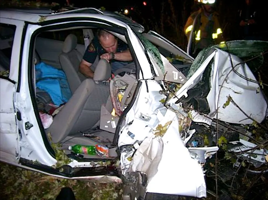 In this Oct. 24, 2006, photo provided by the St. Croix County Sheriff's Office, police investigate the wreckage of a 2005 Chevrolet Cobalt that crashed in St. Croix County, killing Natasha Weigel, 18, and Amy Lynn Rademaker, 15, and injuring the 17-year-old driver, Megan Ungar-Kerns. The vehicle's ignition was found in the accessory position and the air bags didn't deploy. General Motors' recent recall of 2.6 million small cars, including the 2005 Cobalt, has shed light on an unsettling fact: Air bags might not always deploy when drivers - and federal regulators - expect them to. (AP Photo/St. Croix County Sheriff's Office)