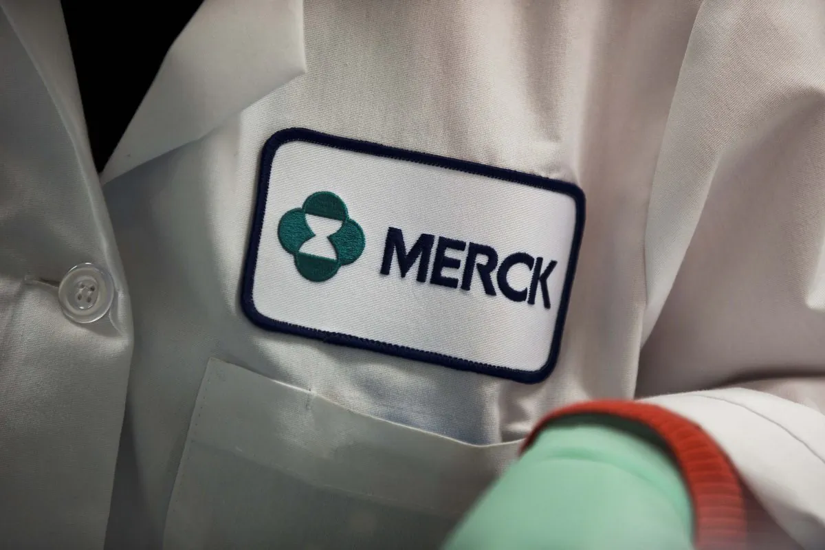 A patch with the Merck logo is shown on a scientist's lab coat in West Point, Pa., Feb. 28, 2013. (Matt Rourke/AP Photo)