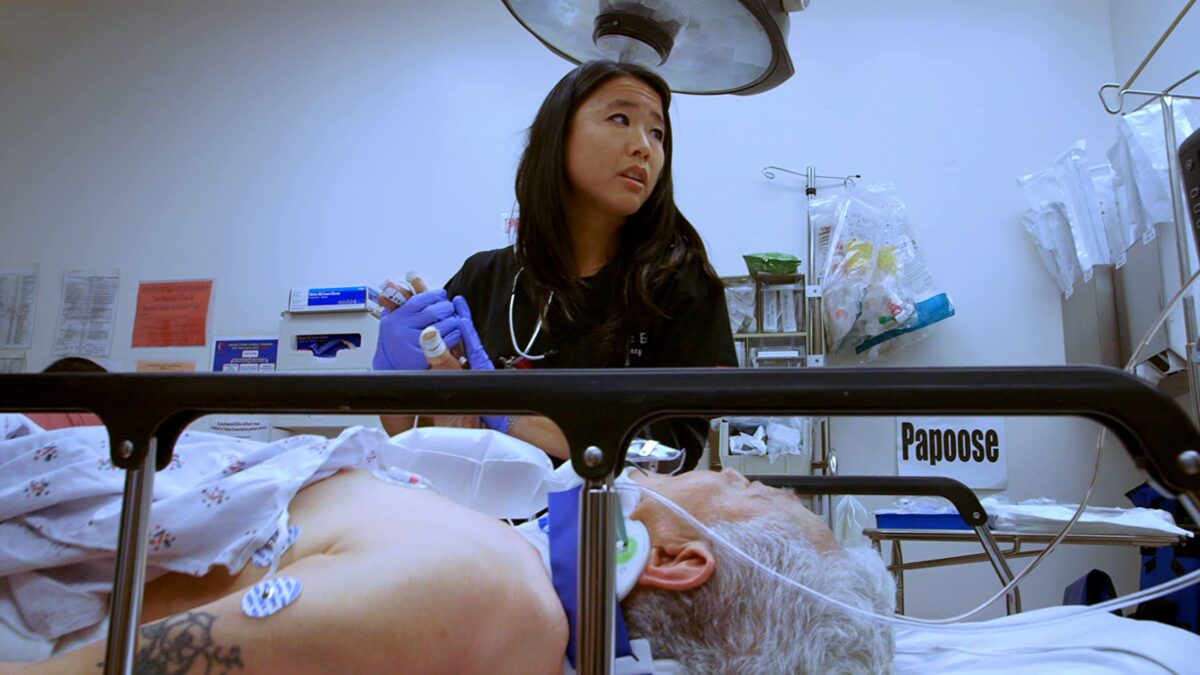Female ER M.D. in blue scrubs in "Code Black"