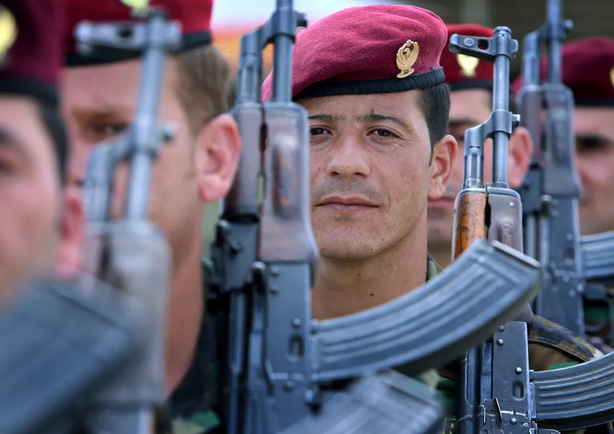 Iraqi Kurdish Peshmerga fighters stand to attention in the grounds of their camp in Arbil, the capital of the autonomous Kurdish region of northern Iraq on June 14, 2014. Iraqi security forces retook a town north of Baghdad from jihadist militants as they readied a fightback after the premier Nuri al-Maliki announced that the cabinet granted him 'unlimited powers' as commander-in-chief of the armed forces. (Safin Hamed/AFP/Getty Images)