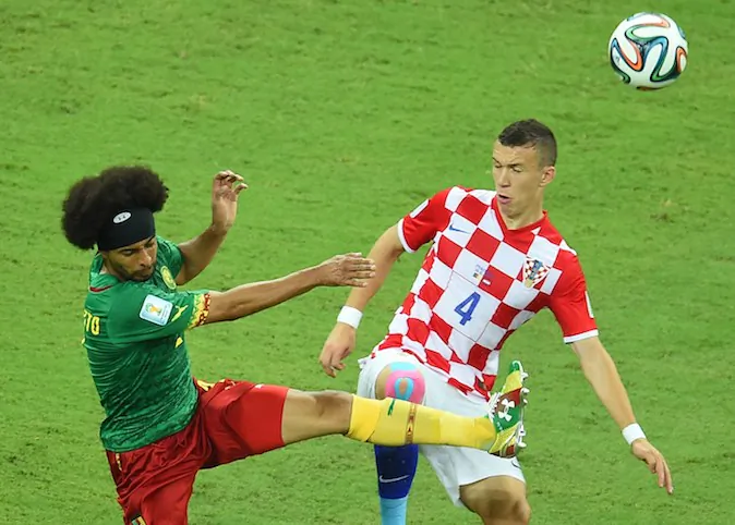 Cameroon's defender Benoit Assou Ekotto (L) vies for the ball with Croatia's midfielder Ivan Perisic, during a Group A football match between Cameroon and Croatia in the Amazonia Arena in Manaus during the 2014 FIFA World Cup on June 18, 2014. (EMMANUEL DUNAND/AFP/Getty Images)