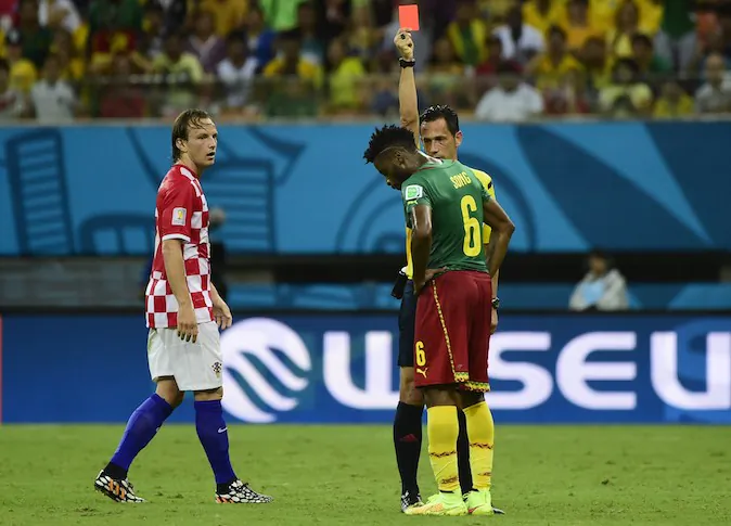 Portuguese referee Pedro Proenca Oliveira Alves Garcia (R) issues a red card to Cameroon's midfielder Alexandre Song (C) as Croatia's midfielder Ivan Rakitic (L) looks on during the Group A football match between Cameroon and Croatia at The Amazonia Arena in Manaus on June 18, 2014, during the 2014 FIFA World Cup. (PIERRE-PHILIPPE MARCOU/AFP/Getty Images)