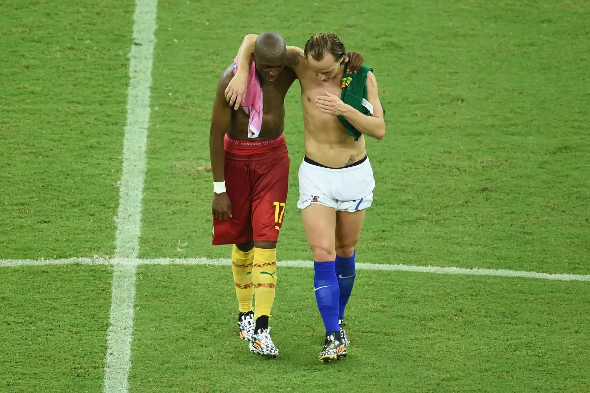 Cameroon's midfielder Stephane Mbia (L) and Croatia's midfielder Ivan Rakitic (R) speak at the end of the Group A football match between Cameroon and Croatia in the Amazonia Arena in Manaus during the 2014 FIFA World Cup on June 18, 2014. (EMMANUEL DUNAND/AFP/Getty Images)