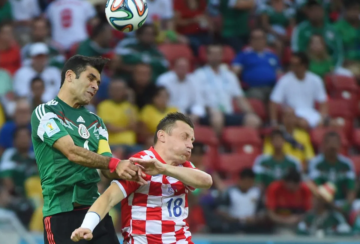 Croatia's forward Ivica Olic (R) and Mexico's defender Rafael Marquez vie for the ball during a Group A football match between Croatia and Mexico at the Pernambuco Arena in Recife during the 2014 FIFA World Cup on June 23, 2014. (EMMANUEL DUNAND/AFP/Getty Images)