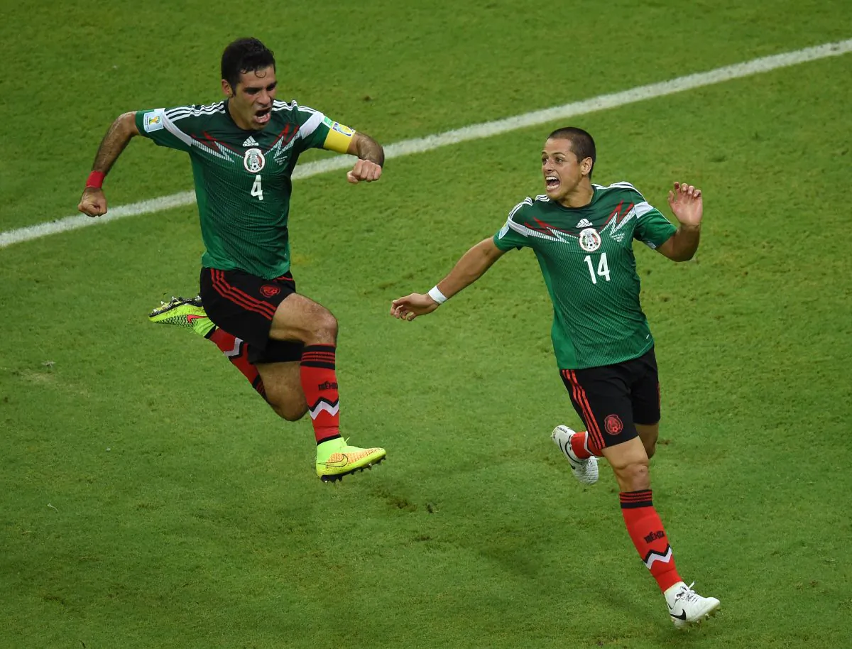 Mexico's defender and captain Rafael Marquez (L) celebrates with Mexico's forward Javier Hernandez after Marquez headed his team's first goal during a Group A football match between Croatia and Mexico at the Pernambuco Arena in Recife during the 2014 FIFA World Cup on June 23, 2014. (JAVIER SORIANO/AFP/Getty Images)