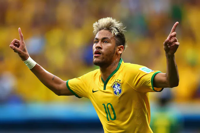 Neymar of Brazil celebrates scoring his team's second goal and his second of the game during the 2014 FIFA World Cup Brazil Group A match between Cameroon and Brazil at Estadio Nacional on June 23, 2014 in Brasilia, Brazil. (Clive Brunskill/Getty Images)