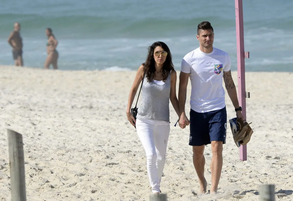 France's forward Olivier Giroud and his wife Jennifer Giroud walk on a beach in Rio de Janeiro during the 2014 FIFA World Cup football tournament on June 26, 2014. (FRANCK FIFE/AFP/Getty Images)