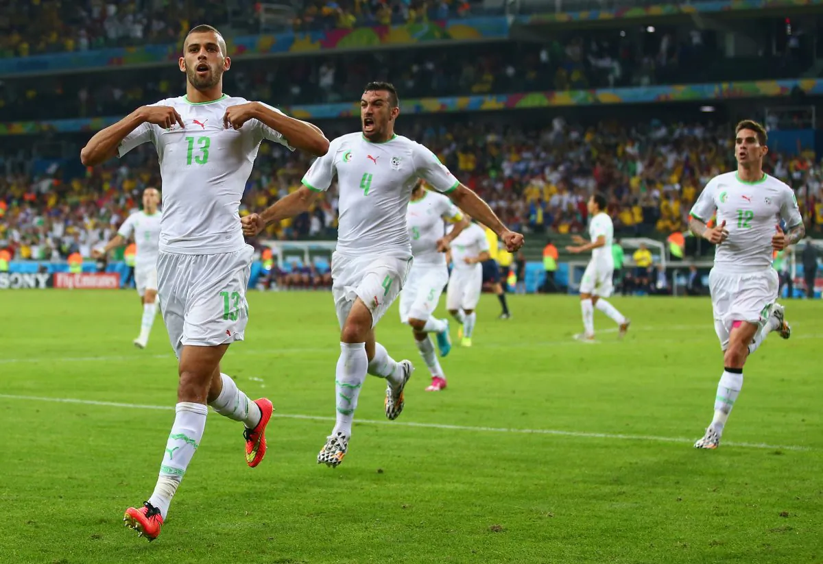 Islam Slimani of Algeria (L) celebrates scoring his team's first goal with teammates Essaid Belkalem (C) and Carl Medjani (R) during the 2014 FIFA World Cup Brazil Group H match between Algeria and Russia at Arena da Baixada on June 26, 2014 in Curitiba, Brazil. (Photo by Julian Finney/Getty Images)