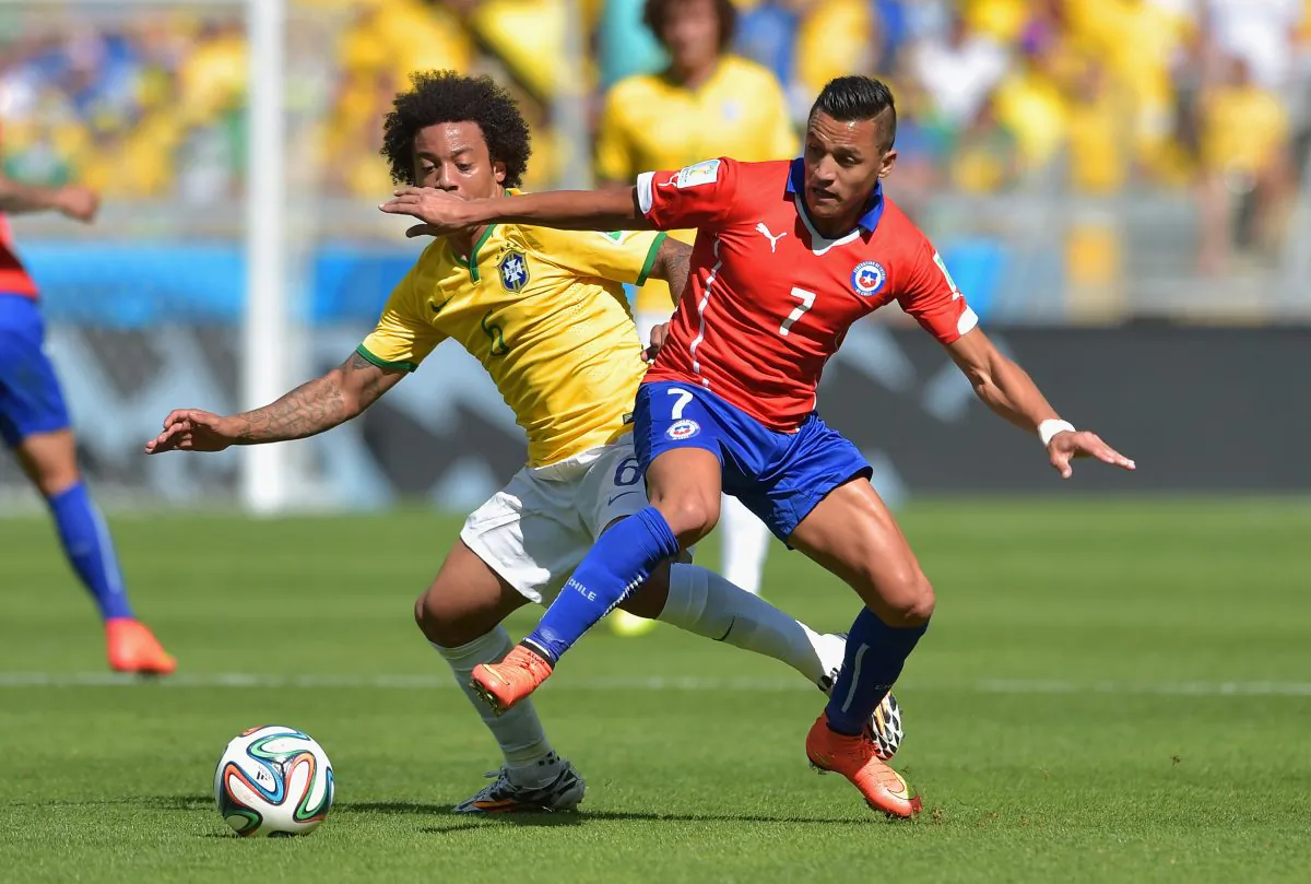 Alexis Sanchez of Chile and Marcelo of Brazil compete for the ball during the 2014 FIFA World Cup Brazil round of 16 match between Brazil and Chile at Estadio Mineirao on June 28, 2014 in Belo Horizonte, Brazil. (Buda Mendes/Getty Images)